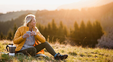 Woman in field at sunset